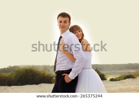 fun portrait of the bride and groom on the beach