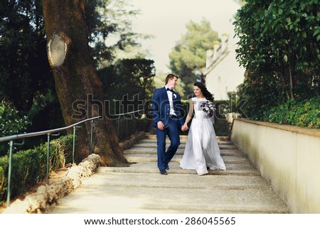 luxurious bride and groom walking spring park of tivoli italy