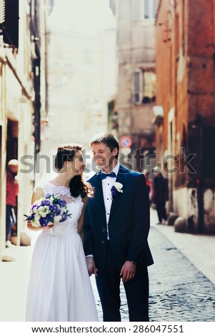 romantic gentle luxury brunette bride and groom are walking at the streets of tivoli italy