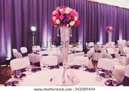 Luxury stylish wedding reception purple decorations expensive hall lights and flowers