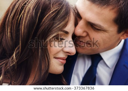 Sensual romantic newlywed couple, hugging, face closeup