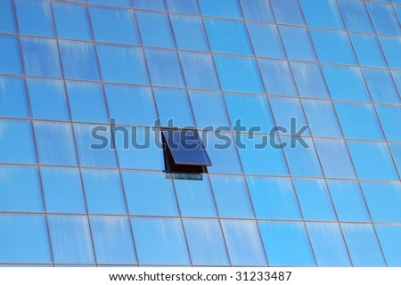 abstract geometric structure formed by windows of modern office building