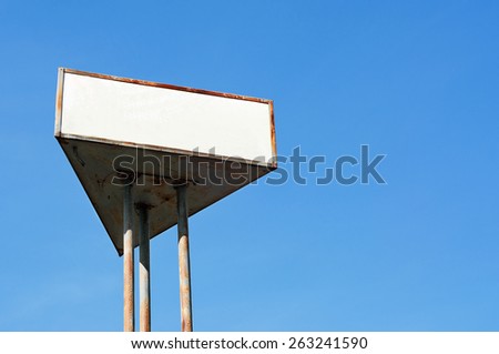 Billboard on the background of pure blue sky. There is a white space for text