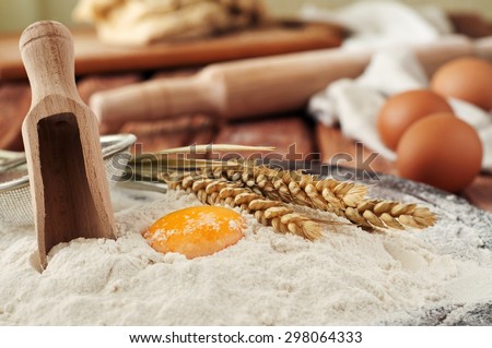 Egg yolk in flour close up on a wooden table in a bakery. Rural or rustic style. Copy space. Free space for text