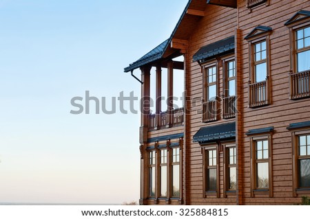 House with log. The facade of elite houses of wood against blue sky background