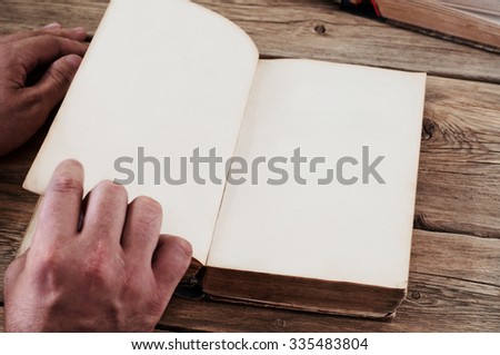 Man turns the page old book close up. Copy space. Free space for text. Top view