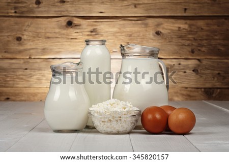 Dairy products (milk, cottage cheese, yogurt) and eggs closeup on a wooden background