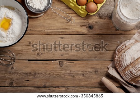 Ingredients for homemade dough (butter, egg, milk , flour). Ingredients for bakery products. Top view. Copy space. Free space for object