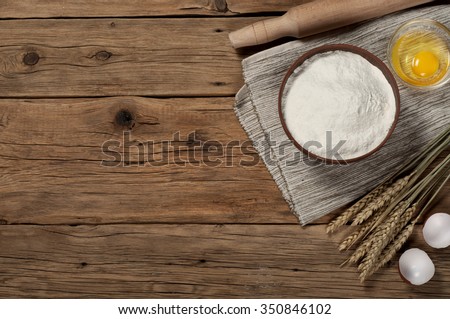 Flour in a bowl with ingredients for preparing baked products. Top view. Copy space. Free space for text