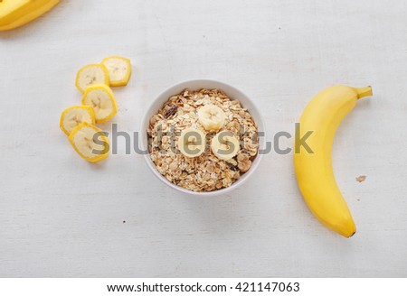 Healthy breakfast with muesli and banana, top view