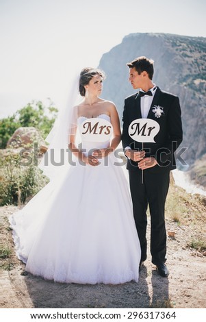 Funny bride and groom with Mr and Mrs signs. Happy wedding day
