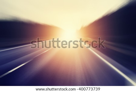 abstract blurred image, sunrise on an empty road