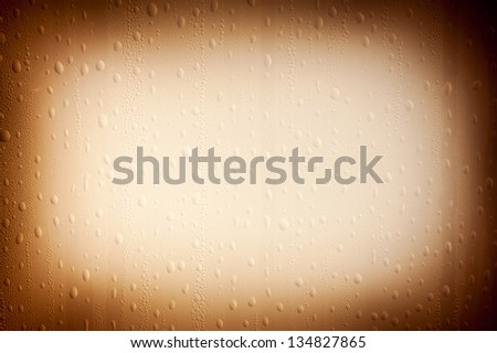 Condensation and water drops on window sepia background, transparent glass of window, wet textured abstract with dark vignette. Horizontal orientation, nobody.