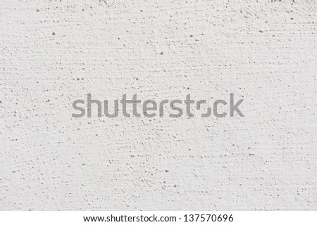 White grained paint wall texture abstract, bright wall surface detail background in horizontal orientation, nobody.