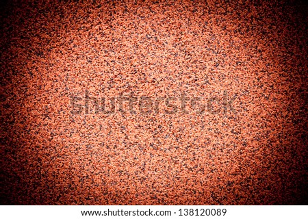 Grained brown grit wall texture abstract with dark vignette, wall surface bright in central part detail background in horizontal orientation, nobody.