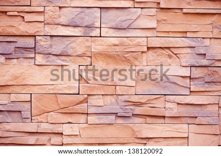 Slate tiles purple beige rock abstract, wall cladding detail, fine-grained rock decoration on building in beige with purple color mix, wall surface background in horizontal orientation, nobody.
