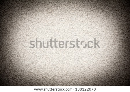 Grained paint white wall texture abstract with dark vignette, wall surface bright in central part detail background in horizontal orientation, nobody.