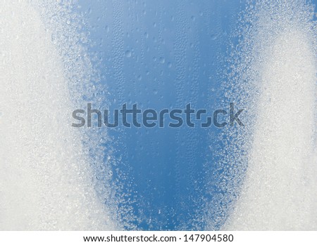 Water condensation on window frozen snow on glass, transparent glass of window in winter in contact with morning warm sunlight. Horizontal orientation, nobody.