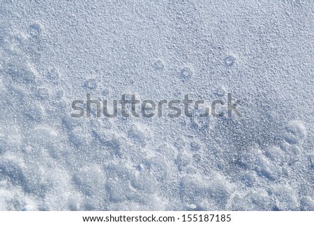 Blue tone bubbles and circles in frozen lake, textured snow on ice abstract, snow background of white season in winter weather, horizontal orientation, nobody.