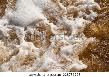 Pouring water foam abstract, froth white bubbles and water flowing in river, horizontal orientation, nobody.