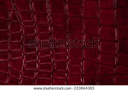Maroon snake leather cloth imitation, sheet texture abstract, claret tinted wrinkled material surface background in horizontal orientation, nobody.