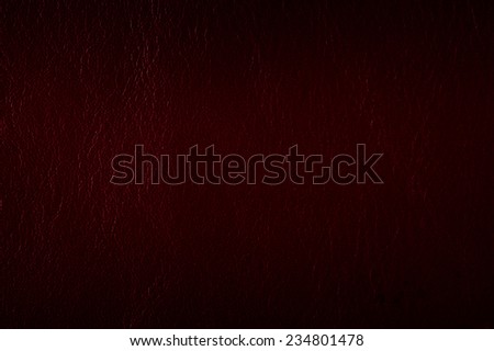 Maroon leather texture abstract with black vignette, material grunge surface background in horizontal orientation, digitally altered, nobody.