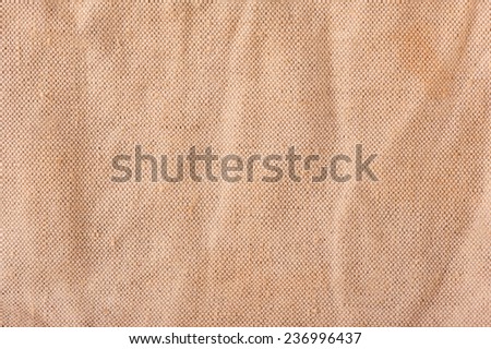Beige linen cloth texture abstract, bright rough plain seamless surface background in horizontal orientation, nobody.
