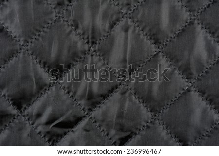 Black quilted cloth texture abstract, material crumpled surface background in horizontal orientation, no digitally altered, nobody.