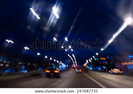 Cars motion street night lights abstract, city traffic trails effect shoot from window of rush car, fast driving movement, horizontal orientation, nobody.