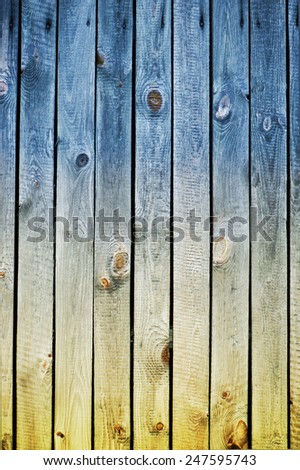 Blue yellow toned boards texture abstract, planks flat surface in Ukraine colors symbol, wood background in vertical orientation, nobody.