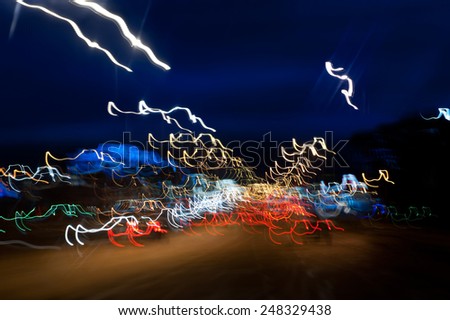 Cars driving motion night lights abstract, city traffic trails effect shoot from window of rush car, fast driving movement, horizontal orientation, nobody.