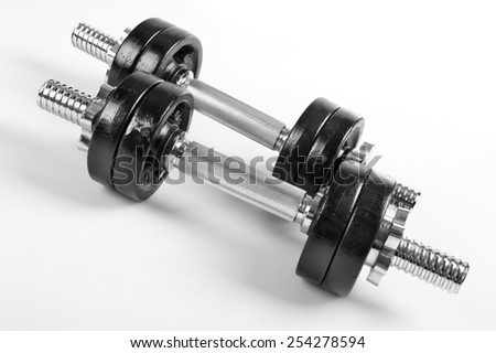 Chrome heavy hand barbells black weights on white background in horizontal orientation, nobody.