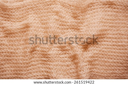 Beige fluffy knitted fabric texture abstract, blank cloth surface, crumpled bright material background in horizontal orientation, nobody.