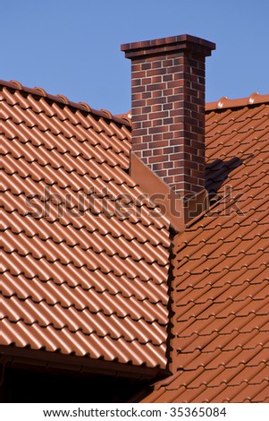 Overlapping rows of red tiles sheet roof with chimney zoom, new building construction of high section in Poland, ridge tiling material regular pattern in vertical orientation, nobody