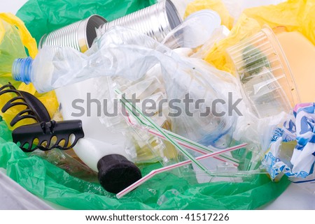 Gather garbage in green plastic bag dump lying on white, early spring season, Clean Up the World gathering. Earth Day and nature dispose, horizontal orientation, nobody.