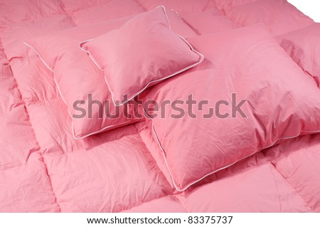 Cotton pink fluffy three pillows and duvet without cover, eiderdown filled with fluff or feathers. Horizontal orientation, nobody.