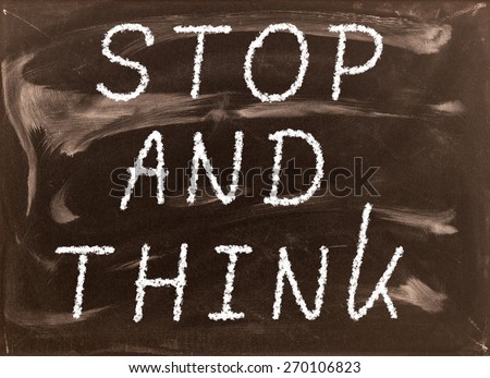 The phrase Stop and Think written on a blackboard as a reminder to take time out and work through our options before taking action