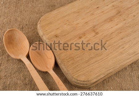Wood texture background. Cutlery on tablecloth burlap sacking. Wooden table close up view from top. Wooden kitchen cutting board retro. Product pages for installation recipe books menu