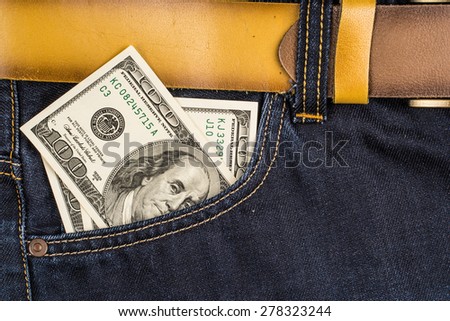 Cash in the front pocket of blue jeans closeup