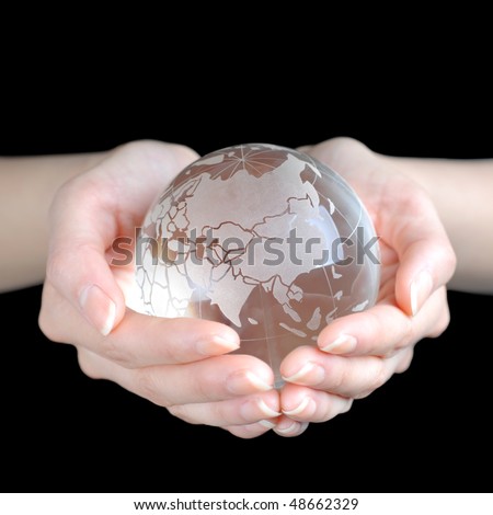 Crystal Earth In Hands isolated on black ground