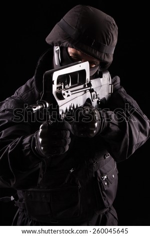 Special soldier with a helmet on his head with his rifle scopes on black background