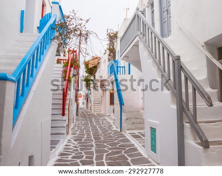 Mykonos town streetview with stairs and blue and grey and red banisters, Greece
