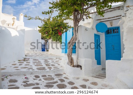 Mykonos streetview with blue door and trees, Greece