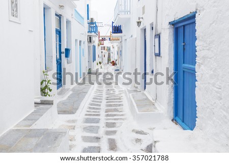 Streetview of Mykonos with whitewashed walls and blue doors and windows, Greece