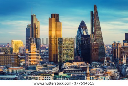 The bank district of central London with famous skyscrapers and other landmarks at sunset with blue sky - London, UK