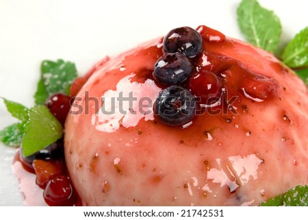 Close-up delicious summer pudding with some red fruits and mint leafs