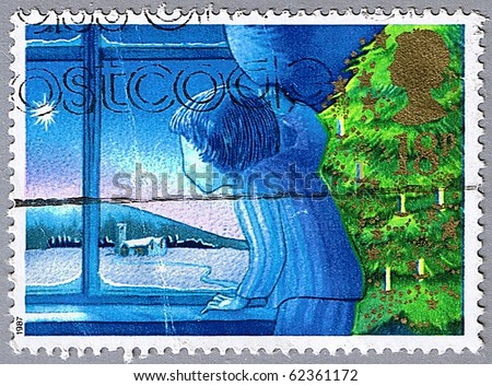 GREAT BRITAIN - CIRCA 1987: A stamp printed in Great Britain shows a boy looking out the window, series is devoted to Christmas, circa 1987