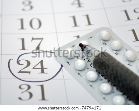 Birth control pills and pen closeup