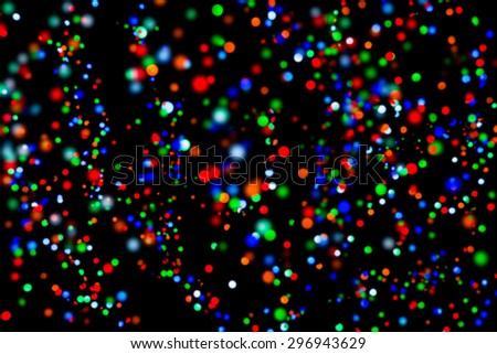 Blurred colorful light dots in black background.