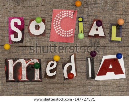 title SOCIAL MEDIA  made of letters from newspapers with pins on the wooden background